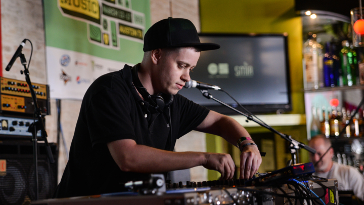 AUSTIN, TX - MARCH 15:  DJ Rustie performs on stage at The British Music Embassy, Latitude 30 on Day 4 of SXSW 2013 Music Festival on March 15, 2013 in Austin, Texas.  (Photo by Andy Sheppard/Redferns via Getty Images)